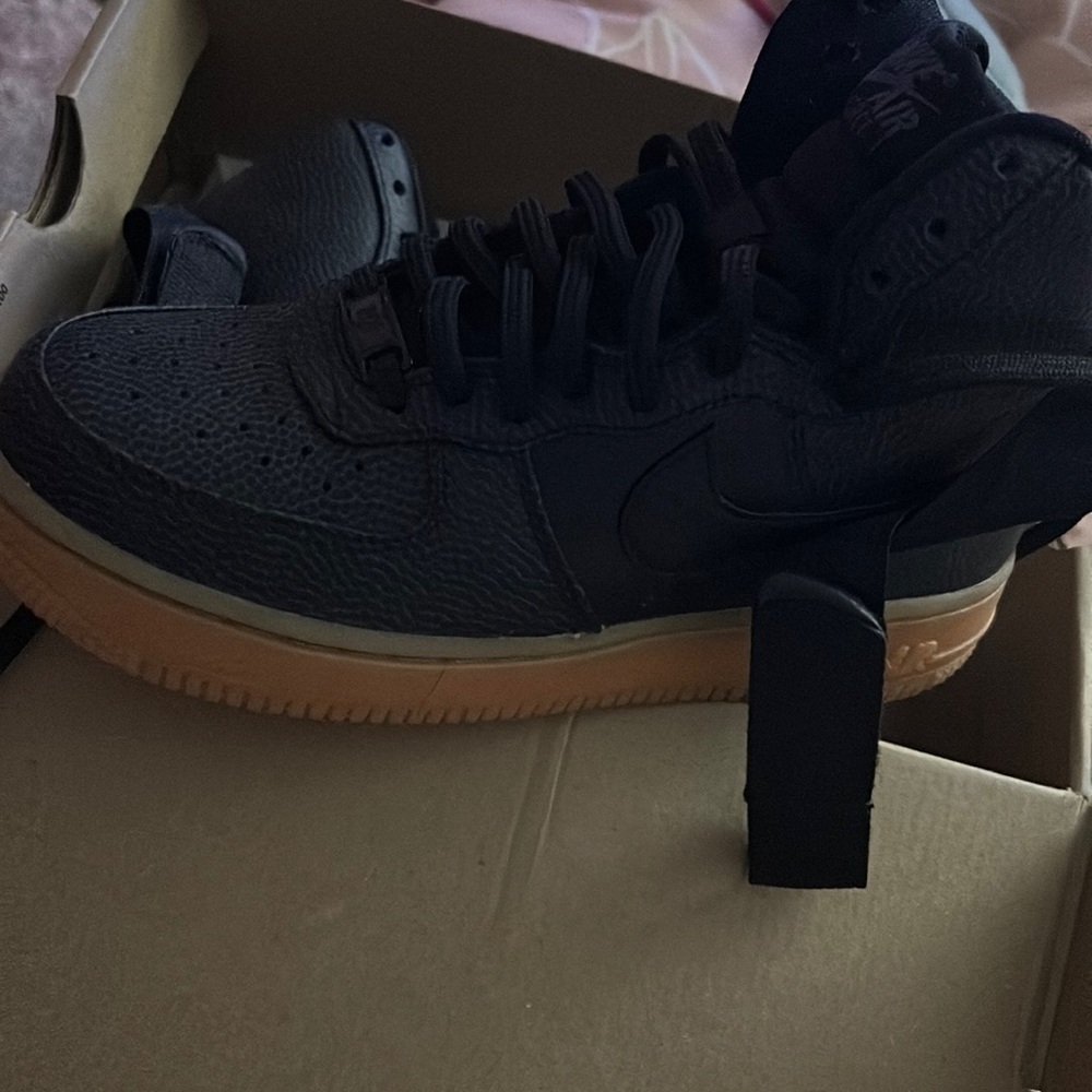 All black air forces with peanut butter bottom